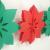 3D-Ansicht der rot-grünen Seidenpapiergirlande mit weihnachtlichem Weihnachtssterne Motiven.